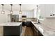 Kitchen featuring stainless steel appliances, modern two-tone cabinets, marble countertops, and island at 1451 Cherryville Rd, Shelby, NC 28150