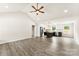 Spacious open floor plan with gray flooring, a ceiling fan, and a modern kitchen area at 1451 Cherryville Rd, Shelby, NC 28150