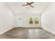 Open living space with wood-look flooring, a ceiling fan, and windows offering an outdoor view at 1451 Cherryville Rd, Shelby, NC 28150