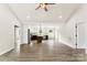 Bright and airy living room with an open layout, modern flooring, and a view into the kitchen at 1451 Cherryville Rd, Shelby, NC 28150