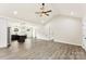 Open-concept living area with wood-look floors, high ceilings, and a modern kitchen in the background at 1451 Cherryville Rd, Shelby, NC 28150