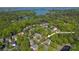 Aerial view of the neighborhood with lush trees and a lake nearby at 19113 Southport Dr, Cornelius, NC 28031