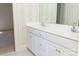 Bright bathroom featuring a double sink vanity with white cabinets, floral knobs, and a large mirror at 19113 Southport Dr, Cornelius, NC 28031