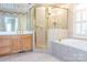 Well-appointed bathroom featuring a glass-enclosed shower, a soaking tub, and a vanity at 19113 Southport Dr, Cornelius, NC 28031
