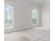 Spacious bedroom with plush carpeting and two large windows offering ample natural light at 19113 Southport Dr, Cornelius, NC 28031