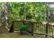 Relaxing wooden deck surrounded by lush greenery and mature trees, providing a serene outdoor living space at 19113 Southport Dr, Cornelius, NC 28031
