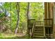 Wooden deck and stairs nestled amongst mature trees on a brick home at 19113 Southport Dr, Cornelius, NC 28031