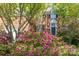 Charming brick home featuring a manicured front yard with beautiful flowering shrubs at 19113 Southport Dr, Cornelius, NC 28031