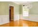 Bright living room with elegant chandelier, wainscoting and hardwood floors at 19113 Southport Dr, Cornelius, NC 28031