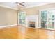 Cozy living room featuring a decorative fireplace, neutral paint, and hardwood floors at 19113 Southport Dr, Cornelius, NC 28031