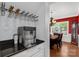 A bar area with a sleek ice maker and glasses rack leads into a formal dining room at 206 Coburn Ct, Fort Mill, SC 29715