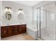Bathroom with a white bathtub, shower, wood cabinets, granite countertops, and double sinks at 206 Coburn Ct, Fort Mill, SC 29715