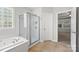Modern bath featuring a stand up shower, bathtub, and tile floors with white fixtures at 206 Coburn Ct, Fort Mill, SC 29715