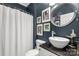 Charming bathroom with vessel sink, dark granite countertop, framed art, and a shower at 206 Coburn Ct, Fort Mill, SC 29715