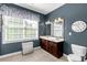 Well-lit bathroom with double vanity, tiled floor, and large window providing ample natural light at 206 Coburn Ct, Fort Mill, SC 29715