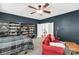 Bedroom with a bed, shelves filled with books, a red sofa, and a ceiling fan at 206 Coburn Ct, Fort Mill, SC 29715