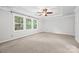 Large bedroom has a ceiling fan, trey ceilings, natural lighting and neutral carpeting at 206 Coburn Ct, Fort Mill, SC 29715