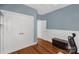 Bedroom with hardwood floors, neutral walls, closet space, and a window at 206 Coburn Ct, Fort Mill, SC 29715