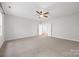 Spacious bedroom with neutral carpeting, a ceiling fan, and an ensuite bathroom at 206 Coburn Ct, Fort Mill, SC 29715