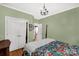 Spacious bedroom with wood floors, floral bedding, closet, and access to other rooms at 206 Coburn Ct, Fort Mill, SC 29715