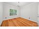 An empty bedroom with hardwood floors, white walls, a ceiling fan, and a window at 206 Coburn Ct, Fort Mill, SC 29715