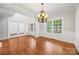 Dining room with hardwood floors, large window, and classic wainscoting at 206 Coburn Ct, Fort Mill, SC 29715