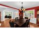Formal dining room features a dark wood table, elegant chandelier, and large windows at 206 Coburn Ct, Fort Mill, SC 29715