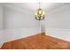 Elegant dining room with wainscoting, hardwood floors, and a beautiful chandelier at 206 Coburn Ct, Fort Mill, SC 29715