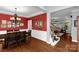 Formal dining room showcasing elegant chandelier, hardwood floors, and access to living room at 206 Coburn Ct, Fort Mill, SC 29715