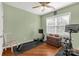 This exercise room has a rower, peloton, wood floors, and a window with natural light at 206 Coburn Ct, Fort Mill, SC 29715