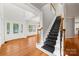 Inviting foyer with hardwood flooring, staircase, and a decorative glass front door at 206 Coburn Ct, Fort Mill, SC 29715