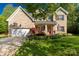 Charming brick home with manicured lawn, flowering plants, and a welcoming red front door at 206 Coburn Ct, Fort Mill, SC 29715