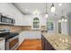 Elegant eat-in kitchen features granite countertops, island with seating, stainless appliances, and lots of natural light at 206 Coburn Ct, Fort Mill, SC 29715