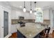 Updated kitchen features granite countertops, stainless appliances, and a breakfast bar at 206 Coburn Ct, Fort Mill, SC 29715