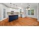 Elegant eat-in kitchen boasts white cabinets, center island, stainless appliances, and lots of natural light at 206 Coburn Ct, Fort Mill, SC 29715