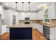 This kitchen features white cabinetry, granite countertops, stainless appliances, and an island at 206 Coburn Ct, Fort Mill, SC 29715