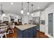 Open kitchen featuring a blue island, stainless appliances, and hardwood floors at 206 Coburn Ct, Fort Mill, SC 29715