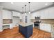 Well-equipped kitchen featuring an island, stainless appliances, granite countertops, and pantry at 206 Coburn Ct, Fort Mill, SC 29715
