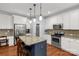 Modern kitchen boasts stainless appliances, granite countertops, island seating, and ample cabinet space at 206 Coburn Ct, Fort Mill, SC 29715