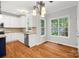 Bright kitchen features white cabinets, hardwood floors, stainless steel appliances, and natural light at 206 Coburn Ct, Fort Mill, SC 29715