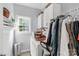 Bright laundry room featuring white cabinets, a window, and a washing machine with a full basket at 206 Coburn Ct, Fort Mill, SC 29715