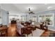 Spacious living room with hardwood floors and a view to a kitchen with an island at 206 Coburn Ct, Fort Mill, SC 29715