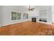 Cozy living room offers a fireplace, built-in shelving, and large windows with backyard views at 206 Coburn Ct, Fort Mill, SC 29715