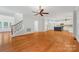 Spacious living room with hardwood floors and a seamless flow into the modern kitchen at 206 Coburn Ct, Fort Mill, SC 29715