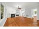 The spacious living area has hardwood floors, fireplace, staircase, and neutral paint colors at 206 Coburn Ct, Fort Mill, SC 29715