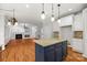 The bright kitchen opens to the living room with a fireplace and hardwood floors throughout at 206 Coburn Ct, Fort Mill, SC 29715