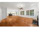 Bright living room features hardwood floors, large windows, ceiling fan, and seamless kitchen access at 206 Coburn Ct, Fort Mill, SC 29715