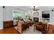 Bright living room featuring large windows, a fireplace, and traditional furnishings at 206 Coburn Ct, Fort Mill, SC 29715