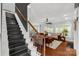 Open-concept living room with hardwood floors, staircase, and natural light at 206 Coburn Ct, Fort Mill, SC 29715