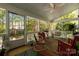 Inviting screened porch with comfortable seating, ceiling fan, and view of wooded backyard at 206 Coburn Ct, Fort Mill, SC 29715